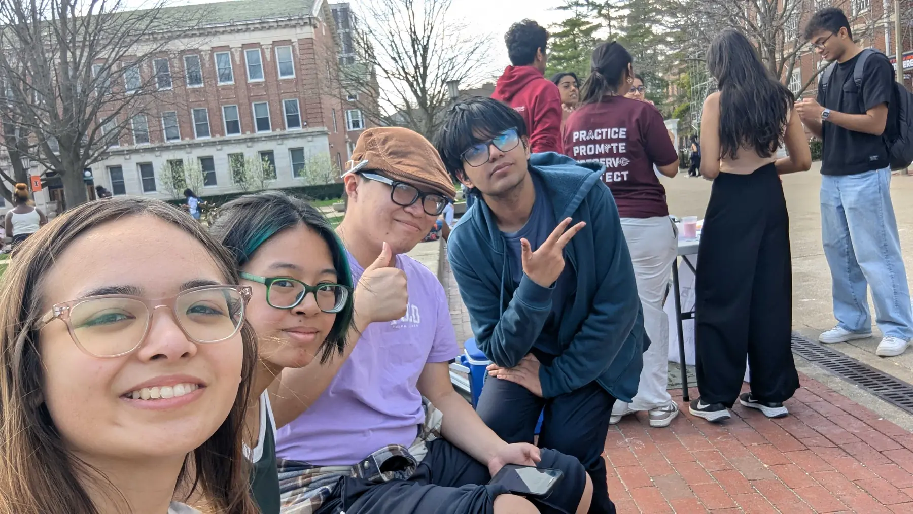 A group of members taking a selfie on the Main Quad